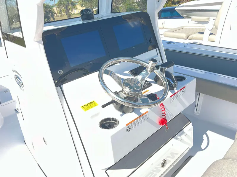 Slide: The Image of 2025 Sportsman 247 MASTERS boat console with steering wheel and dual screens. - 16