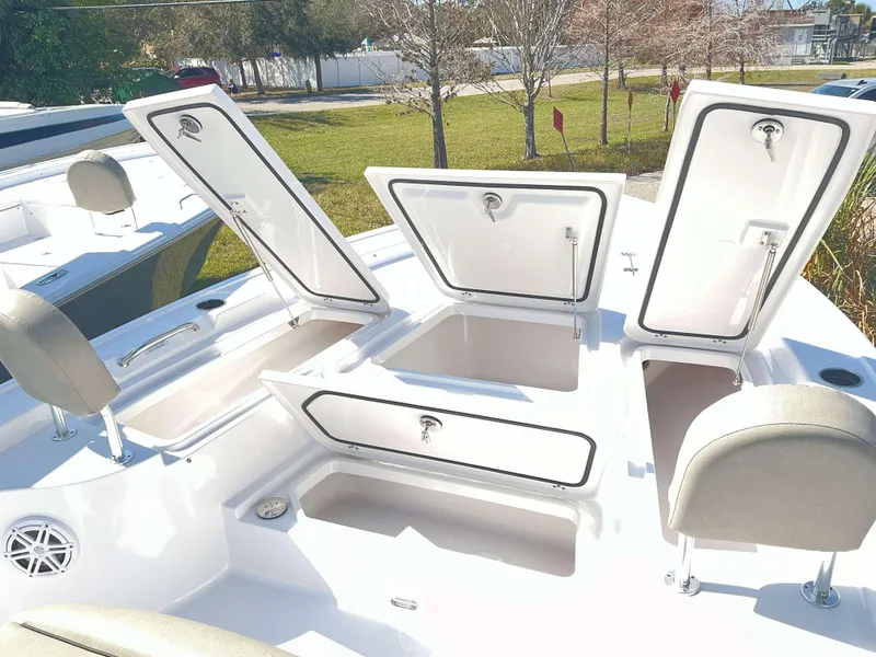 Slide: The Image of 2025 Sportsman 247 MASTERS boat with open storage compartments and seating. - 4