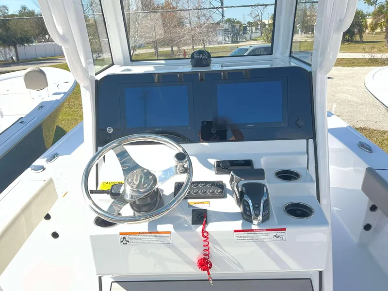 Slide: The Image of 2025 Sportsman 247 MASTERS boat dashboard with dual screens and steering wheel. - 8