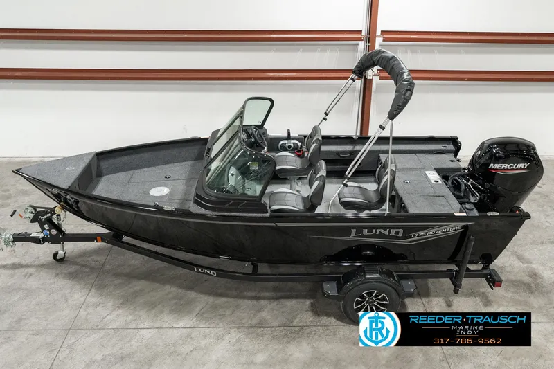 Slide: The Image of 2025 Lund 1775 Adventure Sport boat with Mercury engine on trailer in showroom. - 1