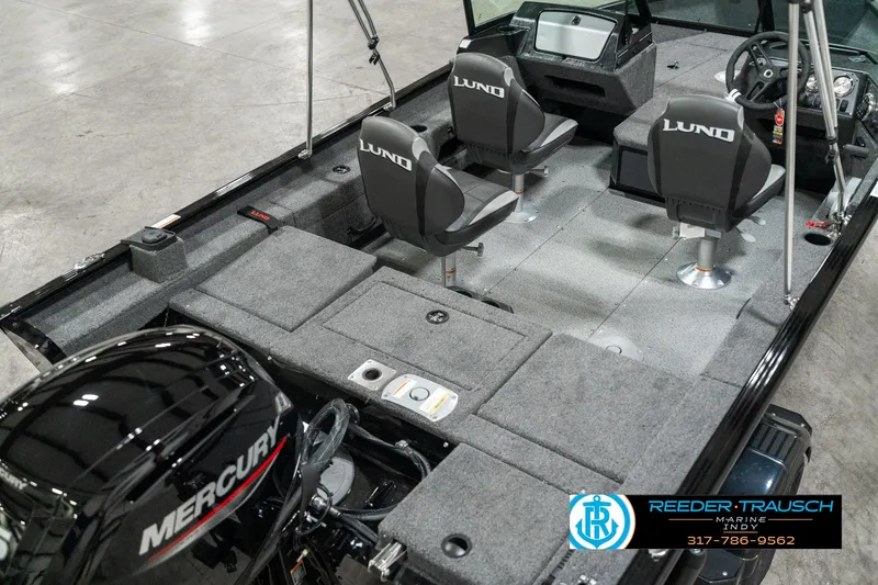 Slide: The Image of 2025 Lund 1775 Adventure Sport boat interior with Mercury engine, featuring seating and control console. - 10