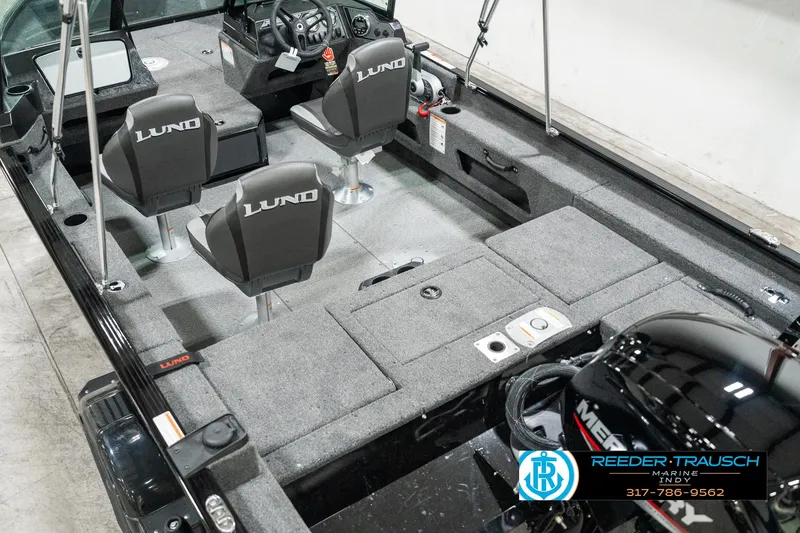 Slide: The Image of 2025 Lund 1775 Adventure Sport boat interior with seating and motor, showcasing spacious design. - 11