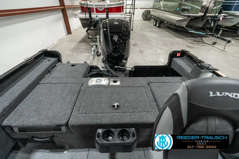 Slide: The Image of 2025 Lund 1775 Adventure Sport boat interior with motor, in showroom setting. - 14