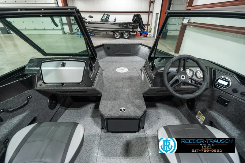 Slide: The Image of 2025 Lund 1775 Adventure Sport boat interior with steering wheel and seating. - 16