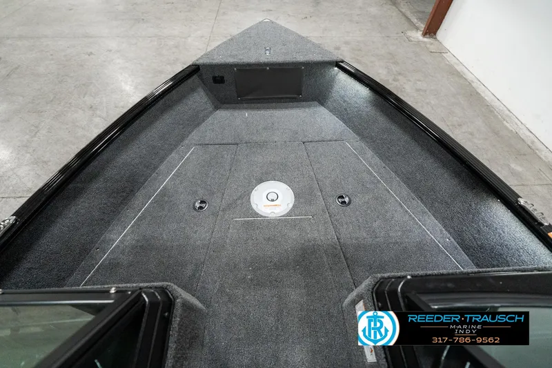 Slide: The Image of 2025 Lund 1775 Adventure Sport boat interior with gray carpet and storage compartments. - 17