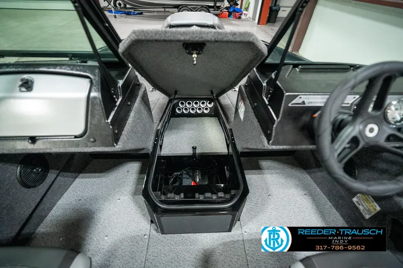 Slide: The Image of 2025 Lund 1775 Adventure Sport boat interior with open storage compartment. - 21