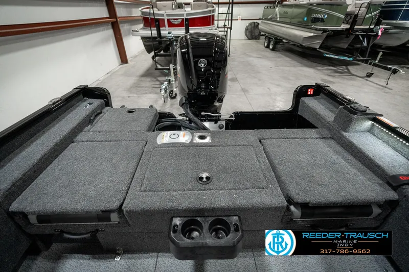 Slide: The Image of 2025 Lund 1775 Adventure Sport boat interior with motor, in showroom setting. - 22