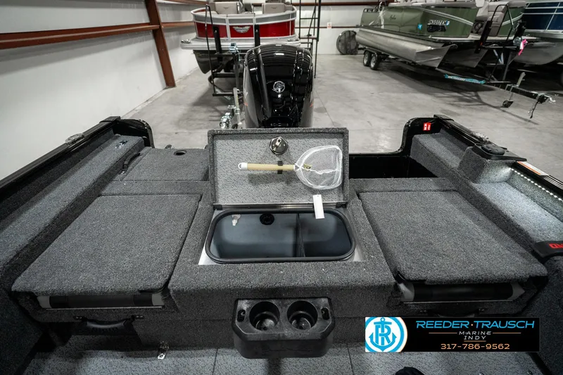 Slide: The Image of 2025 Lund 1775 Adventure Sport boat interior with storage compartments and fishing gear. - 24