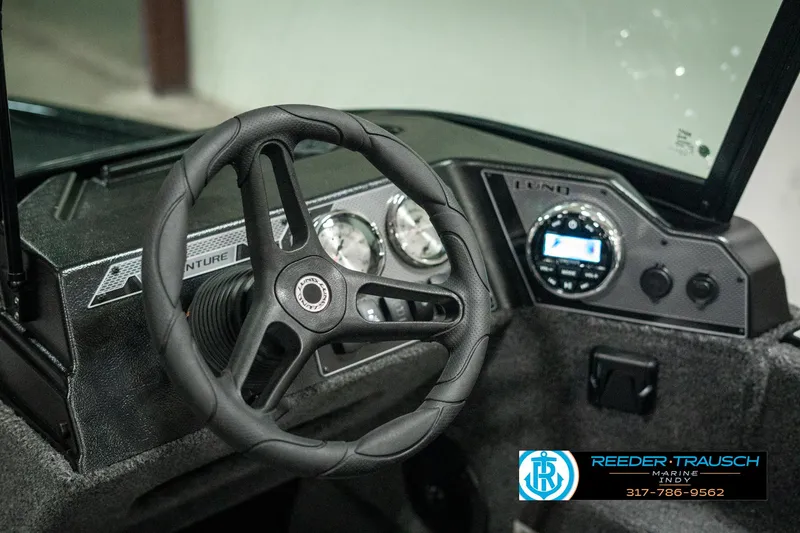 Slide: The Image of 2025 Lund 1775 Adventure Sport dashboard with steering wheel and gauges. - 28