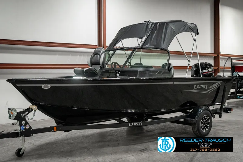 Slide: The Image of 2025 Lund 1775 Adventure Sport boat in showroom, black exterior, on trailer. - 3