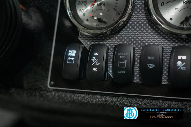 Slide: The Image of Dashboard controls of 2025 Lund 1775 Adventure Sport boat with various switches and gauges. - 32