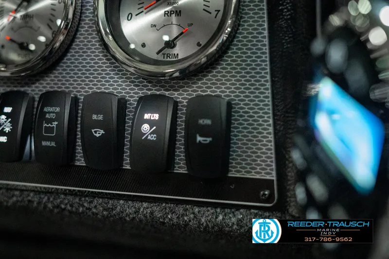 Slide: The Image of Dashboard of 2025 Lund 1775 Adventure Sport boat with control switches and gauges. - 33