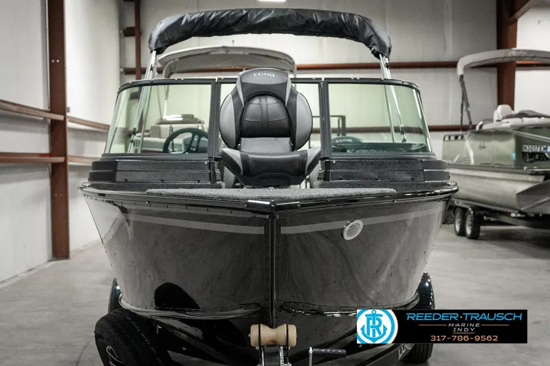 Slide: The Image of 2025 Lund 1775 Adventure Sport boat in showroom, front view, black exterior. - 7