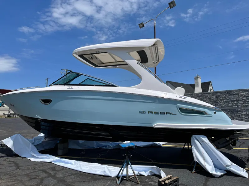 Slide: The Image of 2022 Regal 2800 Bowrider boat on display under a clear blue sky. - 4