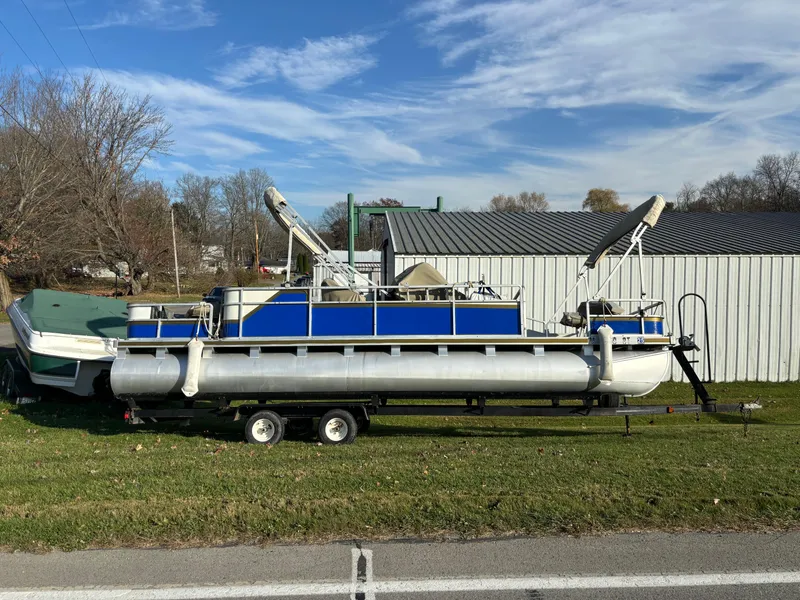 Slide: The Image of 1996 Harris-Kayot Classic 240 O/B pontoon boat on trailer, parked on grass. - 3