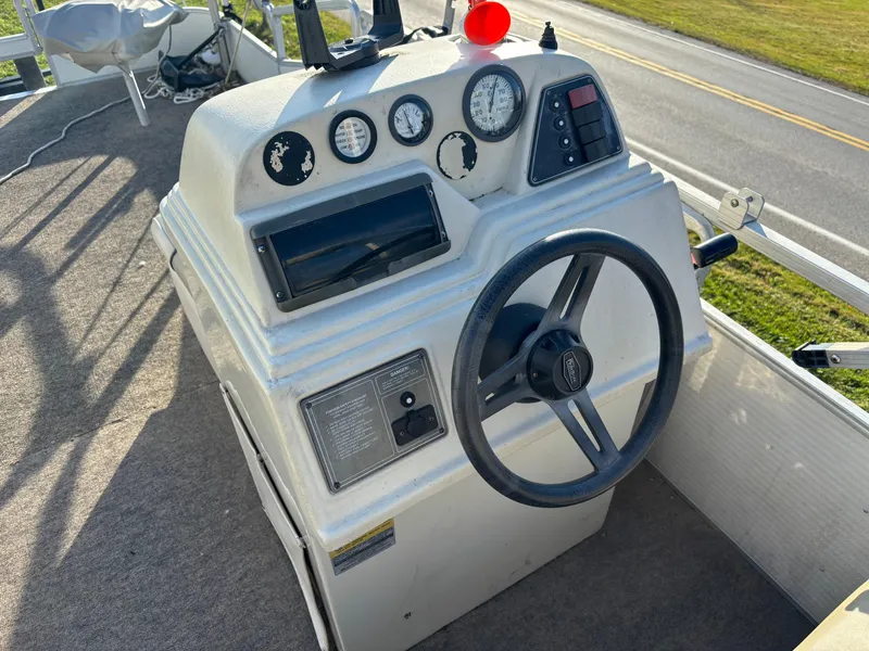 Slide: The Image of 1996 Harris-Kayot Classic 240 O/B boat dashboard with steering wheel and gauges. - 4