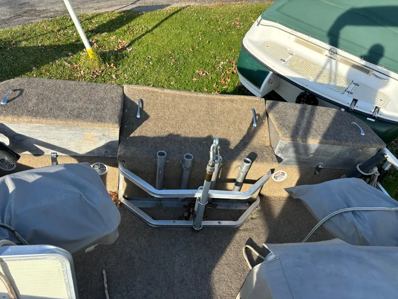 Slide: The Image of 1996 Harris-Kayot Classic 240 O/B boat interior with covered seats and fishing rod holders. - 5