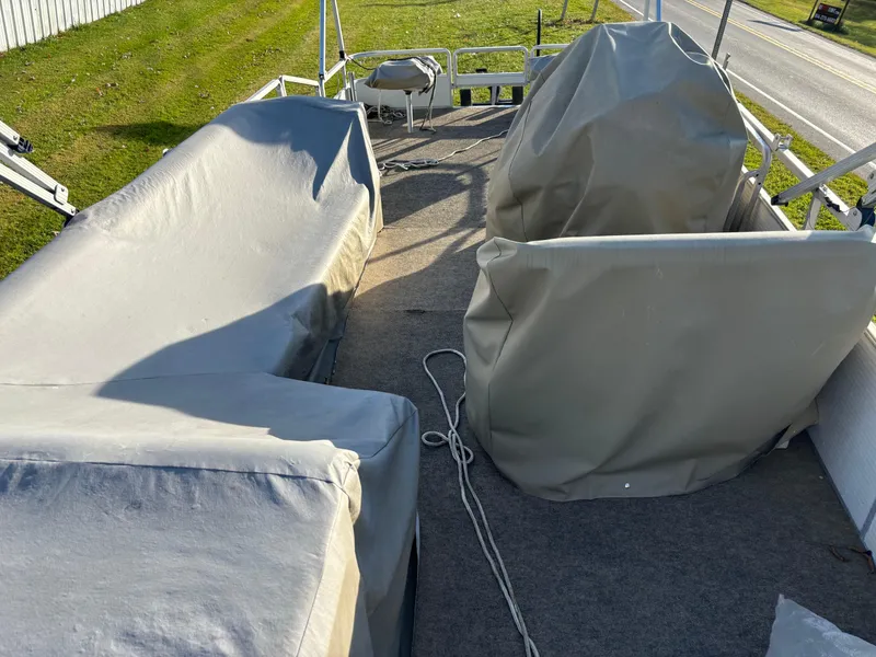 Slide: The Image of 1996 Harris-Kayot Classic 240 O/B boat with covered seating and equipment on deck. - 6