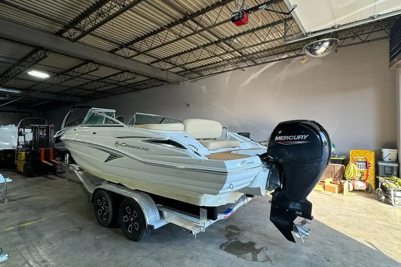 Slide: The Image of 2023 Crownline 215 XS boat with Mercury engine in a warehouse. - 10