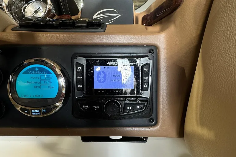 Slide: The Image of Dashboard of 2023 Crownline 215 XS boat with Bluetooth stereo system. - 16