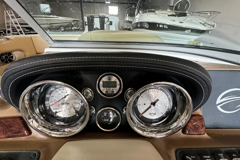 Slide: The Image of Dashboard of 2023 Crownline 215 XS boat with speedometer and RPM gauges. - 8