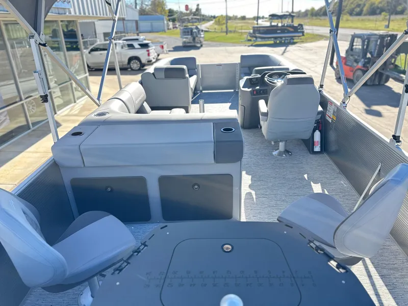 Slide: The Image of 2025 Bennington 23 SS pontoon boat interior with gray seating and steering console. - 4