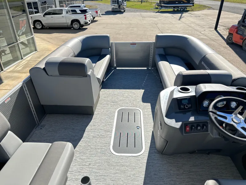 Slide: The Image of 2025 Bennington 23 SS pontoon boat interior with gray seating and modern dashboard. - 6