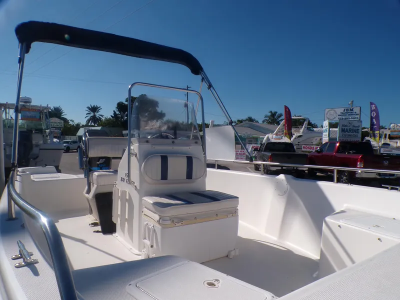 Slide: The Image of 2003 Sea Fox 197 Center Console boat with bimini top in marina setting. - 11