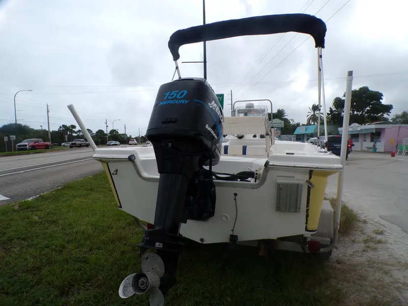 Slide: The Image of 2003 Sea Fox 197 Center Console boat with Mercury 150 outboard motor, parked on grass. - 13