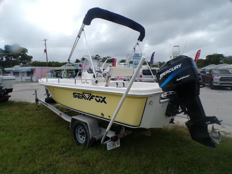 Slide: The Image of 2003 Sea Fox 197 Center Console boat with Mercury outboard motor on trailer. - 2