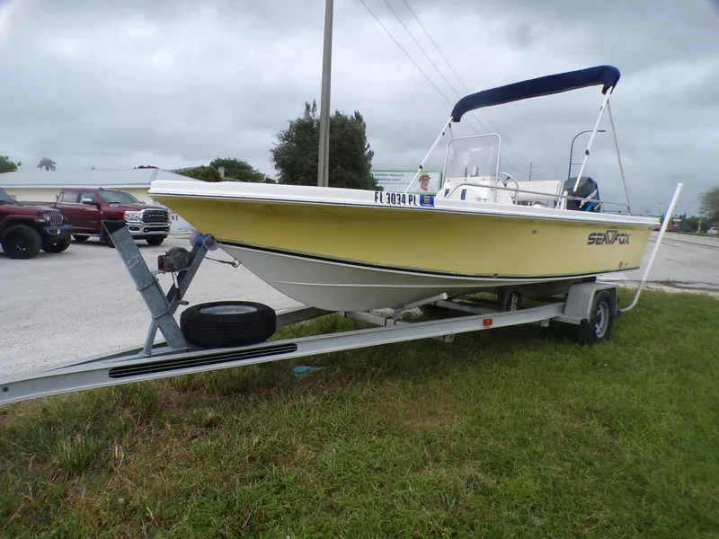 Slide: The Image of 2003 Sea Fox 197 Center Console boat on trailer, parked outdoors. - 3