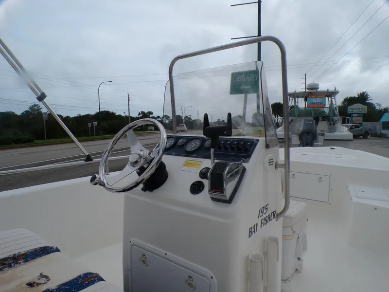 Slide: The Image of 2003 Sea Fox 197 Center Console boat with steering wheel and dashboard controls. - 5