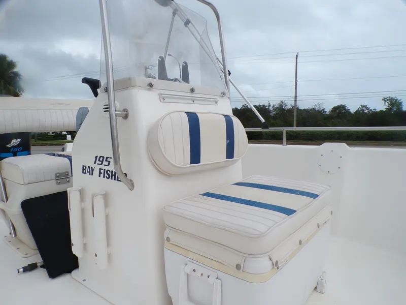 Slide: The Image of 2003 Sea Fox 197 Center Console boat interior with striped seating. - 7