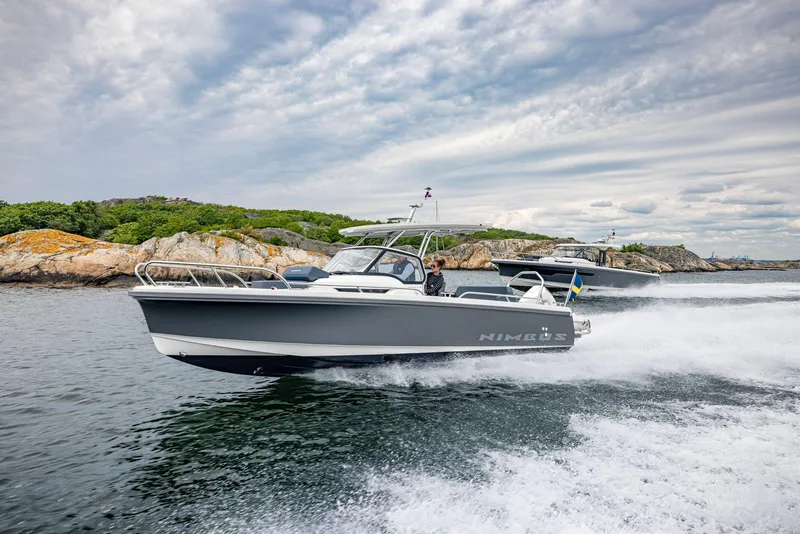 The Image of Nimbus Tender 8, 2025 model, cruising on scenic waters with rocky shoreline. - 0
