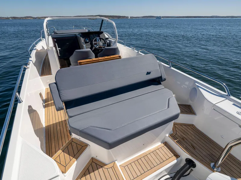 Slide: The Image of Nimbus Tender 8, 2025 model, luxury boat interior with seating, on calm water. - 14