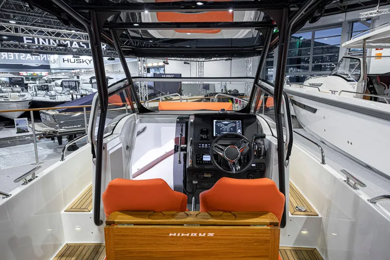 Slide: The Image of Interior view of 2025 Nimbus Tender 8 boat with modern dashboard and orange seats. - 4