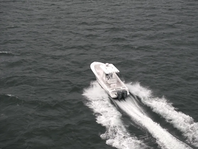 Slide: The Image of 2012 Invincible 33 Open Fisherman boat cruising on open water. - 10