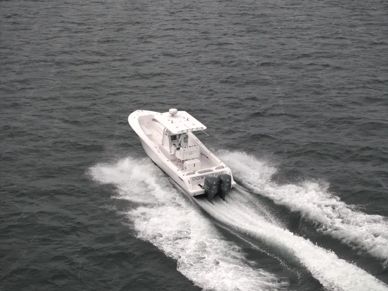 Slide: The Image of 2012 Invincible 33 Open Fisherman boat cruising on open water. - 12