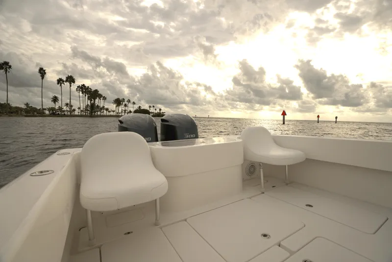 Slide: The Image of 2012 Invincible 33 Open Fisherman boat on calm waters under cloudy sky. - 15