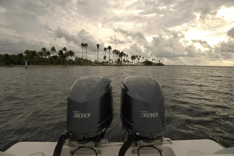 Slide: The Image of 2012 Invincible 33 Open Fisherman with twin Yamaha 300 engines on a tropical waterway. - 16