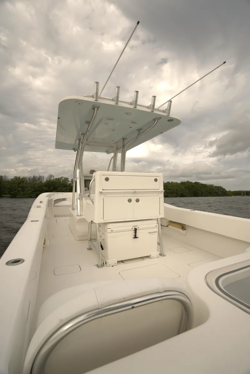 Slide: The Image of 2012 Invincible 33 Open Fisherman boat on water under cloudy sky. - 19