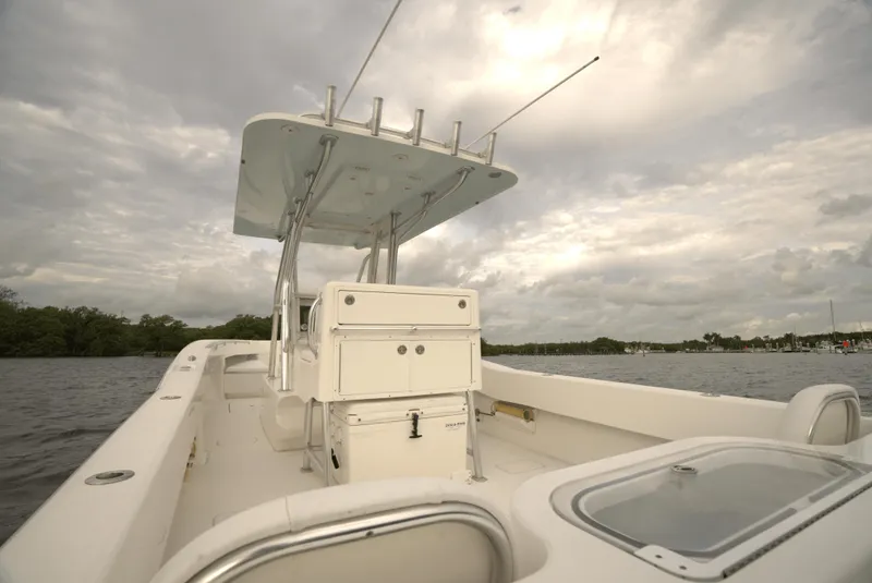 Slide: The Image of 2012 Invincible 33 Open Fisherman boat on calm water under cloudy sky. - 21