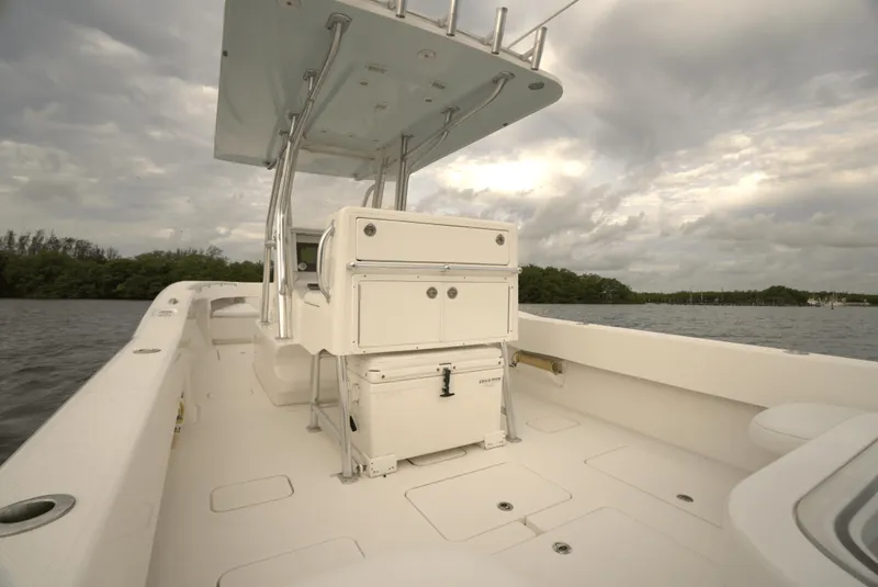 Slide: The Image of 2012 Invincible 33 Open Fisherman boat on water under cloudy sky. - 22