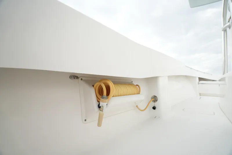 Slide: The Image of 2012 Invincible 33 Open Fisherman boat with coiled hose storage. - 27