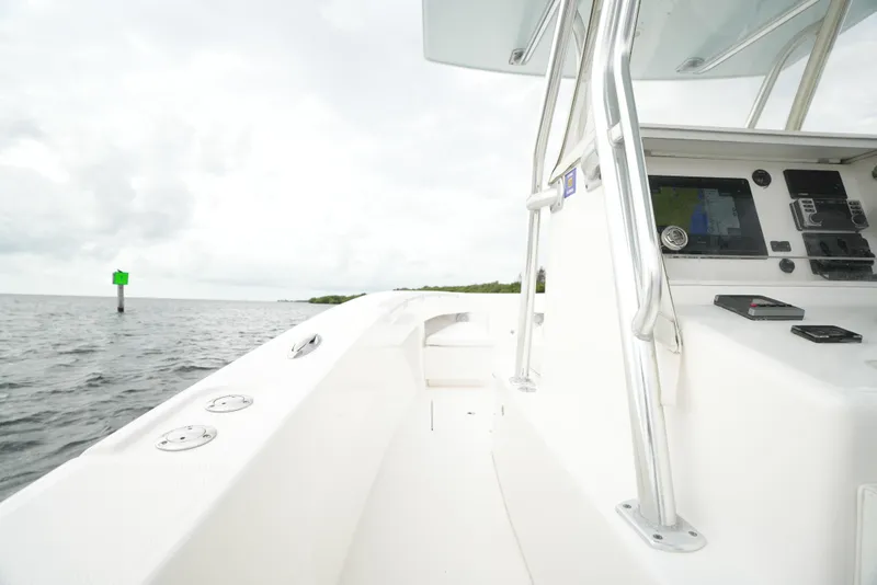 Slide: The Image of 2012 Invincible 33 Open Fisherman boat on calm waters, side view. - 28