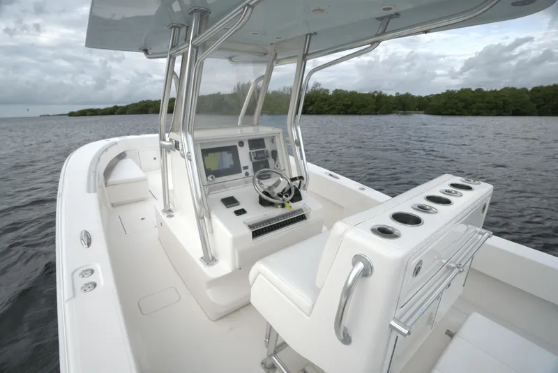 Slide: The Image of 2012 Invincible 33 Open Fisherman boat interior on calm water. - 29