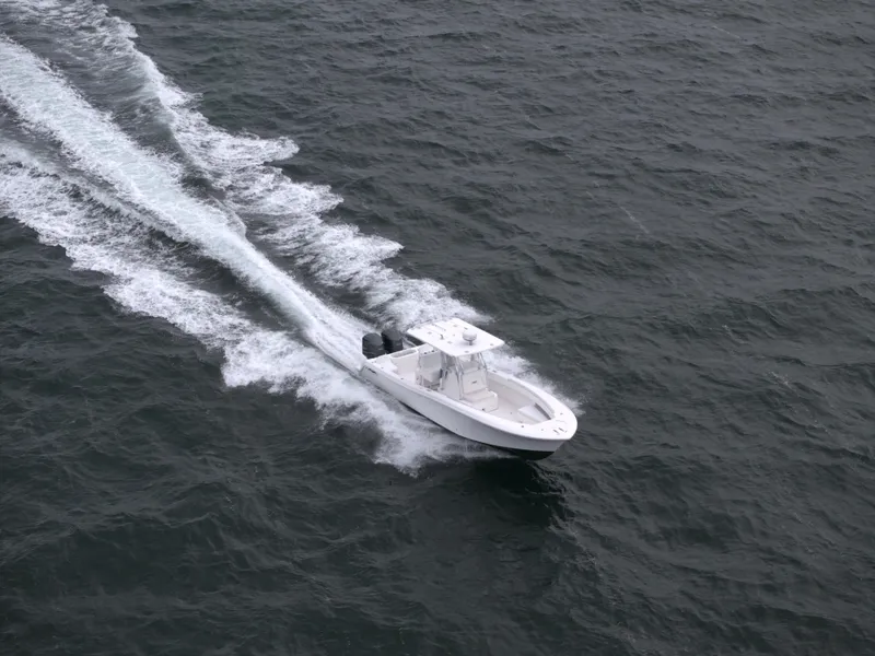 Slide: The Image of Aerial view of 2012 Invincible 33 Open Fisherman boat cruising on the ocean. - 4
