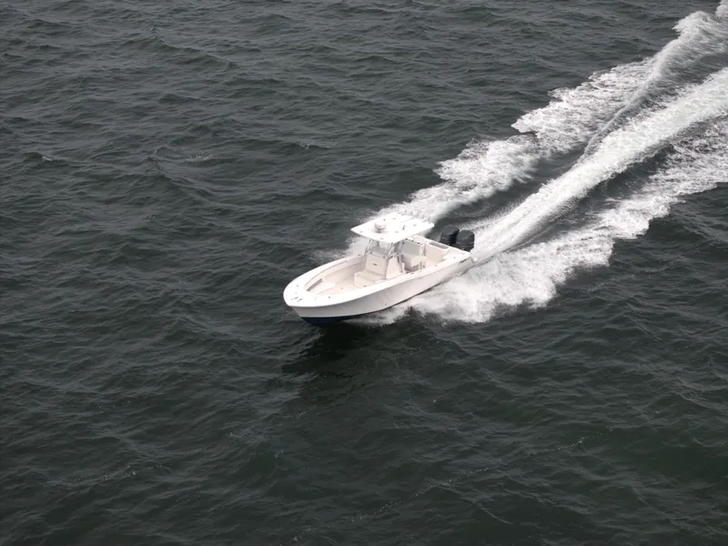 Slide: The Image of 2012 Invincible 33 Open Fisherman boat speeding on open water. - 5