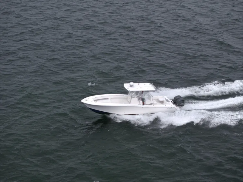 Slide: The Image of 2012 Invincible 33 Open Fisherman boat cruising on open water. - 7