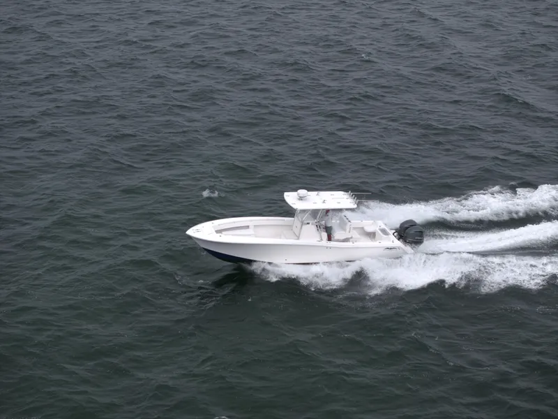 Slide: The Image of 2012 Invincible 33 Open Fisherman boat cruising on open water. - 8